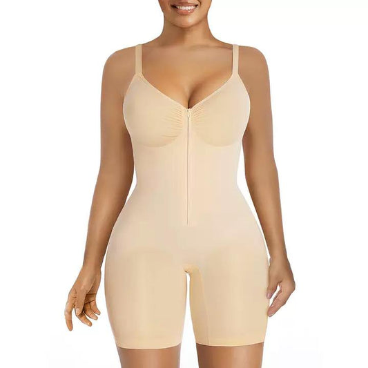 Front view of a model wearing a nude-toned sculpting garment with thin shoulder straps, supportive cup shaping, a long center-front closure, defined waist contour, and mid-thigh coverage.