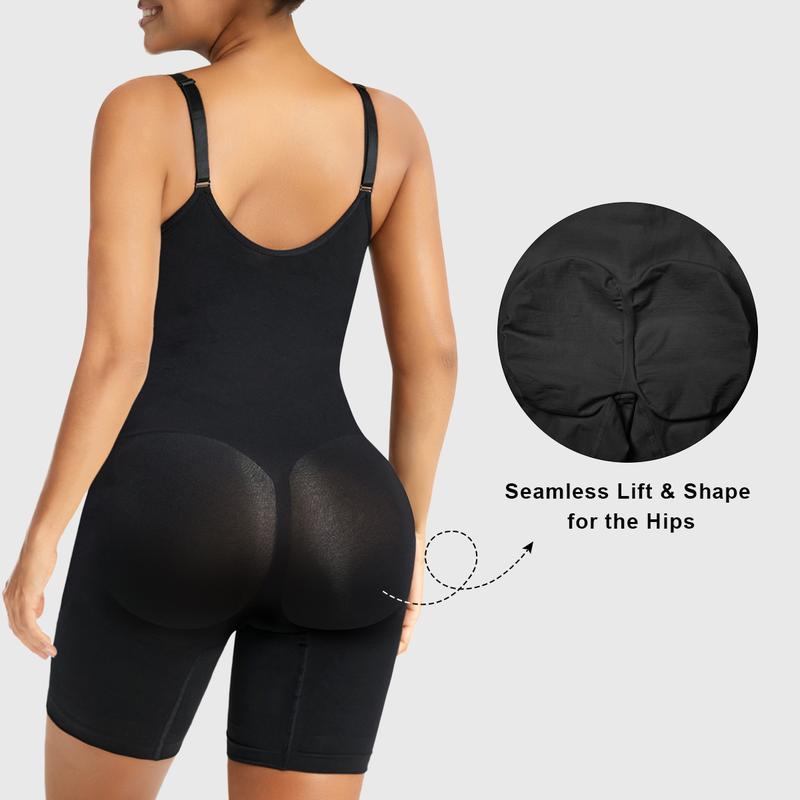 Rear view of a model wearing a fitted black shaping garment, showing adjustable shoulder straps, a smooth back panel, thigh-length coverage, and a contoured rear section designed to create a rounded silhouette.