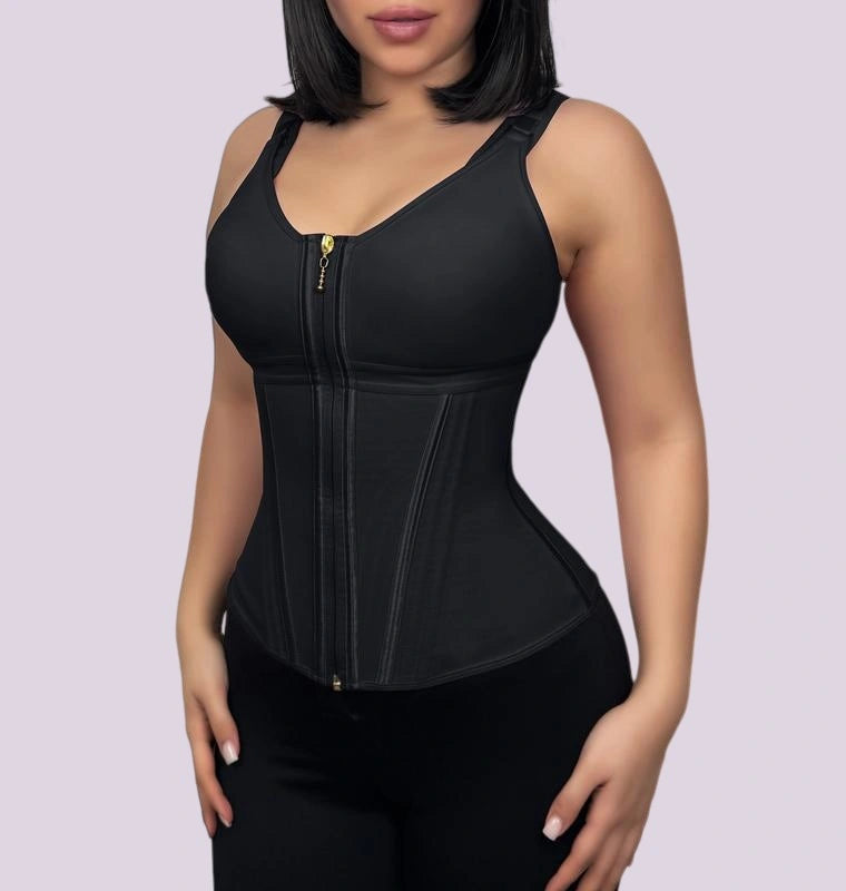 Woman wearing a black shaping bodysuit with a front zipper, wide straps, and contoured panels that define the waistline
