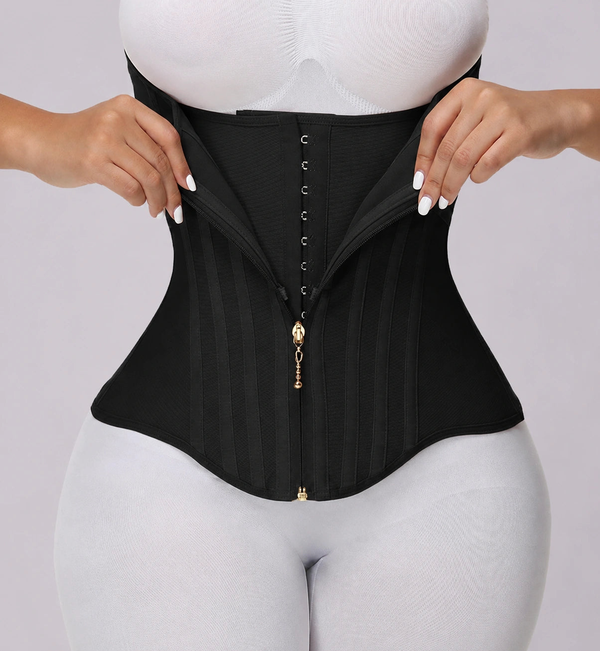 Close-up product view of a black waist shaping corset featuring layered compression fabric, front hook-and-zip closure, vertical boning support, and a curved hem design for enhanced waist definition.