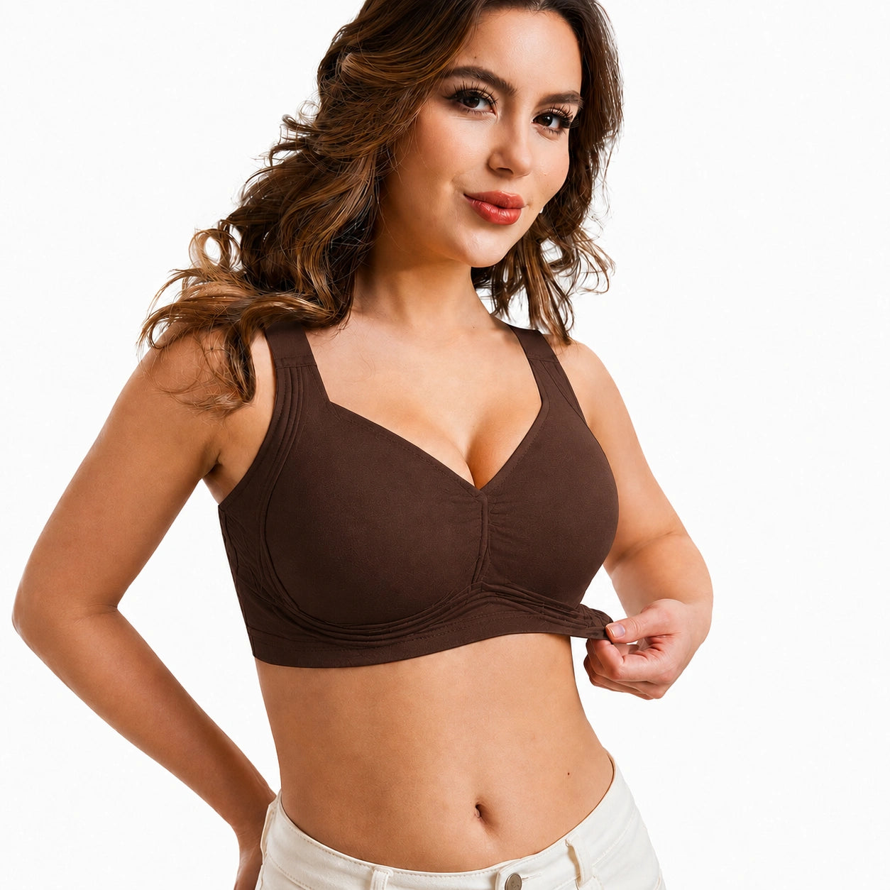 Front-facing studio image of a woman wearing a dark brown supportive bra with wide straps, molded cups, gathered center detail, and a smooth wide underband.