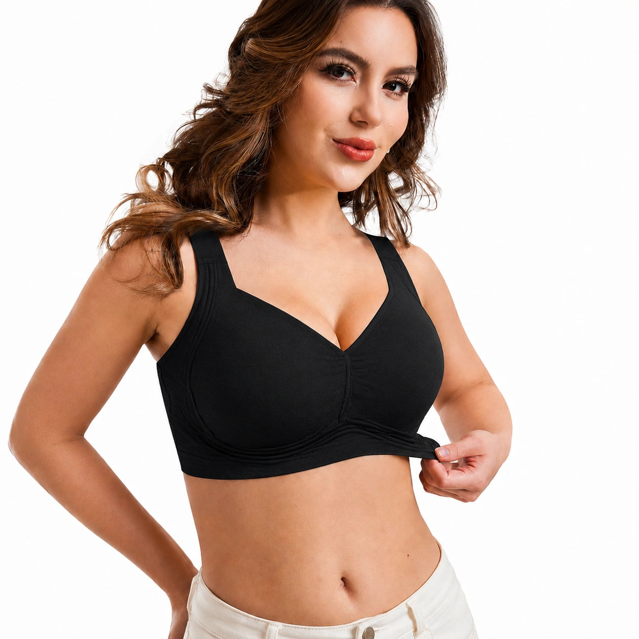 Front view of a woman wearing a black wireless bra with wide shoulder straps, smooth supportive cups, and a gathered center detail against a clean white background.